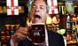 Nigel Farage celebrates with a pint after early local election results in the Hoy and Helmet pub in South Benfleet in Essex