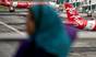 A Malaysian woman watches AirAsia Airbus A320 airplanes parked on the tarmac at the low-cost carrier Kuala Lumpur International Airport 2 (KLIA2) in Sepang on 28 December 2014
